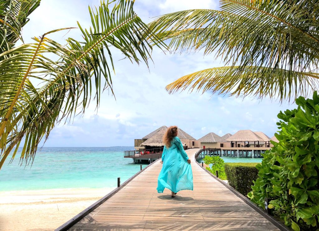 Woman in the summer in the Maldives traveling at a resort.