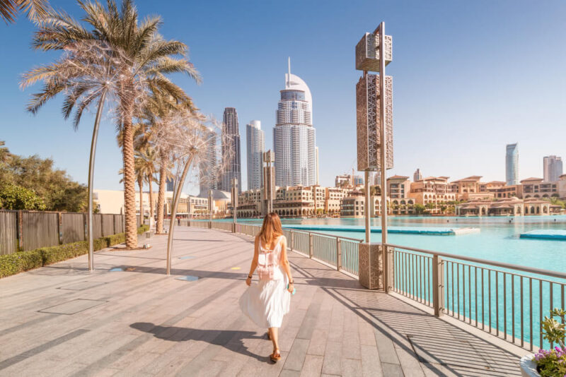 Summer season in Dubai pictured with woman walking in Dubai.