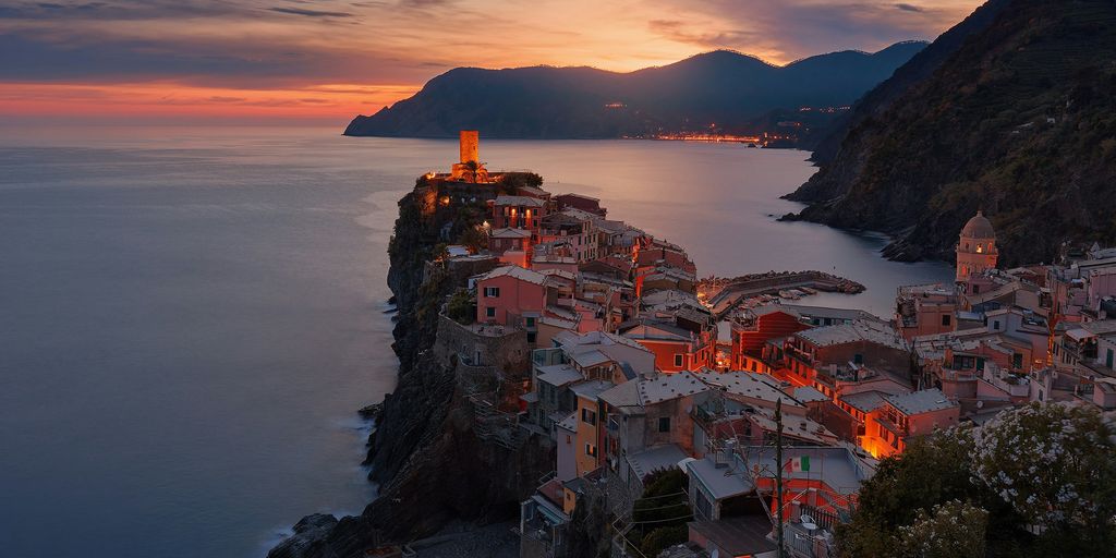 aerial view of village on mountain cliff during orange sunset